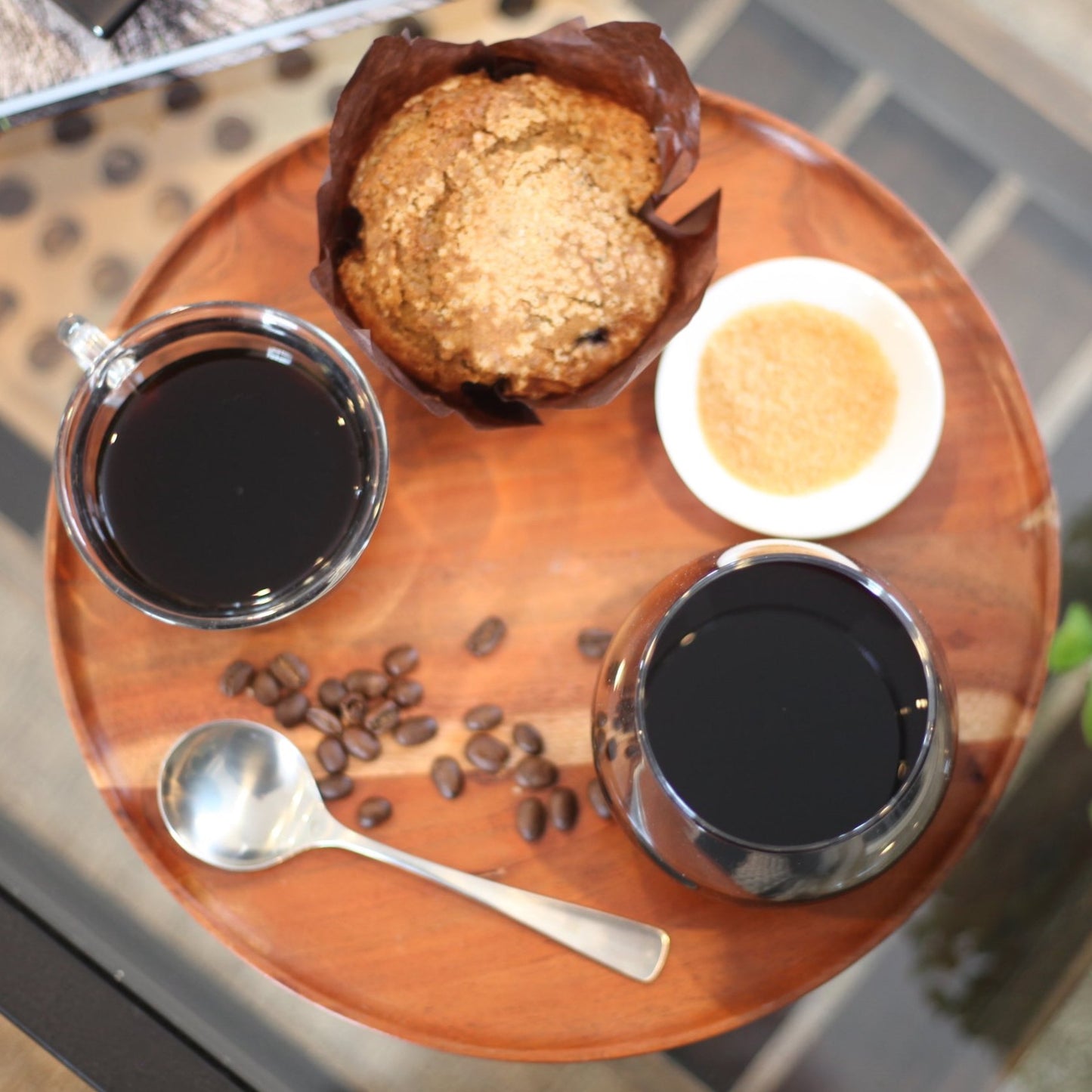 tray with two cups of coffee, a muffin, and a small sugar dish